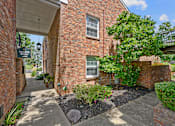 Thumbnail 24 of 32 - a side view of a brick building with a tree and a sidewalk at Olde Towne in Kenwood, Cincinnati, OH, 45243