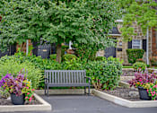 Thumbnail 32 of 32 - a wooden bench sitting in front of a garden at Olde Towne in Kenwood, Ohio