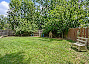 Thumbnail 20 of 32 - a backyard with a bench and a tree at Olde Towne in Kenwood, Cincinnati, Ohio