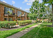 Thumbnail 25 of 32 - a sidewalk in front of a brick apartment building at Olde Towne in Kenwood, Cincinnati, 45243
