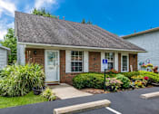 Thumbnail 1 of 32 - the front of a brick house with a porch and a driveway at Parkside at Maple Canyon Apartments, Columbus, Ohio