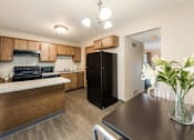 Thumbnail 14 of 32 - a kitchen and dining room with a black refrigerator at Parkside at Maple Canyon Apartments, Columbus, Ohio