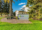 Thumbnail 4 of 32 - a parkide sign in front of a house with trees at Parkside at Maple Canyon Apartments, Columbus