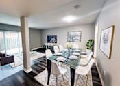 Thumbnail 3 of 33 - A dining room with a glass table and white chairs at A62 Apartments, Indianapolis, IN 46220