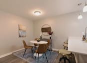 Thumbnail 8 of 33 - A dining room with a round table and chairs at A62 Apartments, Indianapolis, IN