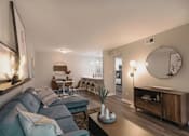 Thumbnail 10 of 33 - A living room with a grey couch and a wooden coffee table at A62 Apartments, Indianapolis 46220