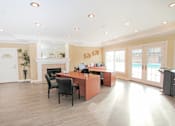 Thumbnail 27 of 33 - A spacious office with a desk, chairs, and a fireplace at A62 Apartments, Indianapolis, IN