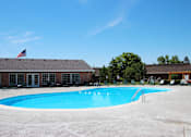 Thumbnail 32 of 33 - A swimming pool in front of a building with an American flag at A62 Apartments, Indianapolis 46220