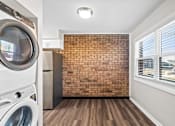 Thumbnail 4 of 32 - A laundry room with a washer and dryer.
