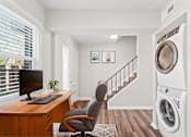 Thumbnail 7 of 32 - A washing machine is in a laundry room.