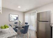 Thumbnail 10 of 32 - A modern kitchen with a dining table set for four.