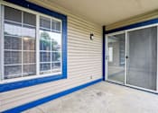 Thumbnail 28 of 38 - A blue and white house with a sliding glass door.