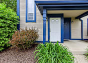 Thumbnail 26 of 38 - A house with a white door and blue trim.