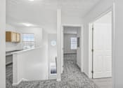 Thumbnail 15 of 54 - A white room with a desk and a window.