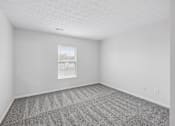 Thumbnail 21 of 54 - A room with a carpeted floor and a window.