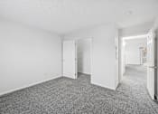 Thumbnail 19 of 54 - A room with white walls and a grey carpet.