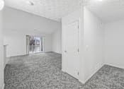 Thumbnail 17 of 54 - A white room with a door and a window.