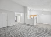 Thumbnail 14 of 54 - A large, empty room with a carpeted floor and white walls.