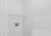Thumbnail 22 of 54 - A white closet with a shelf and a light switch.