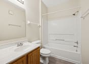 Thumbnail 42 of 54 - A white bathroom with a toilet, sink, and bathtub.