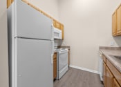Thumbnail 34 of 54 - A kitchen with a refrigerator, microwave, dishwasher, and sink.