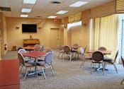 Thumbnail 13 of 25 - A conference room with a table and chairs.