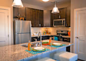 Thumbnail 21 of 42 - a kitchen with a granite counter top and stainless steel appliances at DeSales Flats Apartments*, Cincinnati, 45206