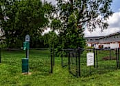 Thumbnail 28 of 40 - A sign in a green post in a grassy area.