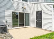 Thumbnail 21 of 40 - A house with a grey siding and a black door.