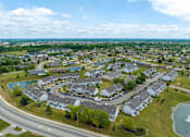 Thumbnail 40 of 40 - A bird's eye view of a residential area with houses and a swimming pool.