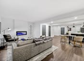 Thumbnail 31 of 65 - a living room and dining area in a 555 waverly unit