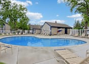 Thumbnail 29 of 38 - A small pool with a deck and a house in the background.