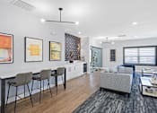 Thumbnail 62 of 80 - a living room with a kitchen and a dining table at Ten31, Dayton, OH, 45458