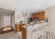 Thumbnail 4 of 44 - A kitchen with a white counter top and a white fridge.