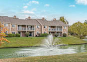 Thumbnail 34 of 46 - A large building with a fountain in front of it.