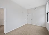Thumbnail 31 of 49 - A white room with a door and a window at Sky Central Apartments, Cincinnati