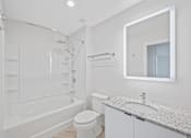 Thumbnail 40 of 49 - A white bathroom with a tub, toilet, and sink at Sky Central Apartments, Ohio, 45202