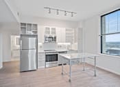 Thumbnail 27 of 49 - A modern kitchen with stainless steel appliances and a large island at Sky Central Apartments, Cincinnati, OH, 45202