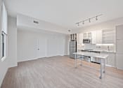 Thumbnail 32 of 49 - A kitchen area with a table and a microwave at Sky Central Apartments, Ohio