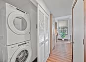Thumbnail 9 of 49 - A laundry room with a washer and dryer stacked on top of each other at Sky Central Apartments, Ohio, 45202
