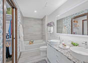 Thumbnail 14 of 49 - A bathroom with a white toilet, sink, and a white bathtub at Sky Central Apartments, Cincinnati, OH