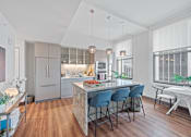 Thumbnail 4 of 49 - A modern kitchen with a dining table and chairs at Sky Central Apartments, Cincinnati, Ohio