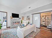 Thumbnail 7 of 49 - A living room with a fireplace and a white couch at Sky Central Apartments, Cincinnati, 45202