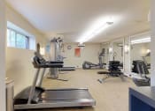 Thumbnail 12 of 18 - Residential gym area with treadmill and various other types of equipment at Gainsborough Court Apartments, Fairfax
