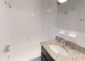 Thumbnail 9 of 18 - Granite counters in bathroom with sink at Gainsborough Court Apartments, Virginia