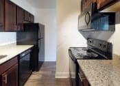 Thumbnail 3 of 18 - Kitchen area with granite counter tops in apartment unit at Gainsborough Court Apartments, Virginia, 22030