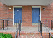Thumbnail 53 of 69 - two blue doors on the side of a brick building