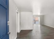 Thumbnail 30 of 69 - the living room and dining room of an apartment with a blue door