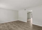 Thumbnail 47 of 69 - the living room of an apartment with white walls and wood flooring