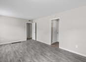 Thumbnail 14 of 69 - the living room of an apartment with white walls and wood flooring